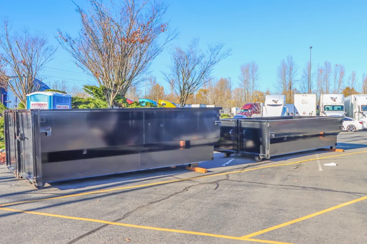 Professional dumpster rental service with roll-off container on residential driveway in Old Saybrook